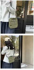Detail of army green nylon drawstring bucket bag showing adjustable strap and zipper pocket