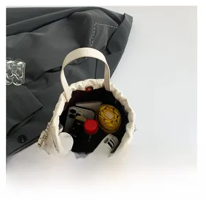 Top view of cream white bucket bag showing large capacity for phone and umbrella