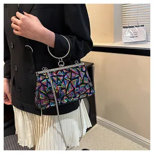 Detail of evening clutch featuring colorful sequins and a large silver metal ring handle
