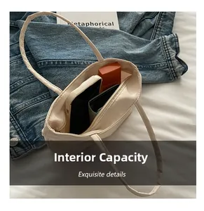 Detailed interior capacity view of beige nylon mini tote bag with everyday essentials