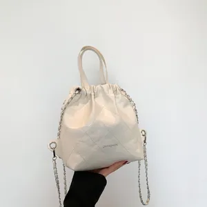 Quilted cream chain backpack with diamond stitching and OH FASHION logo on front