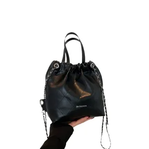 Quilted black leather bucket bag with chain strap and OH FASHION print on white background