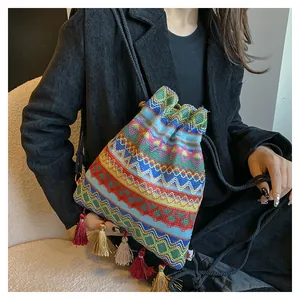 Vista dettagliata della borsa a secchiello boho con ricami colorati e lunghe nappe decorative