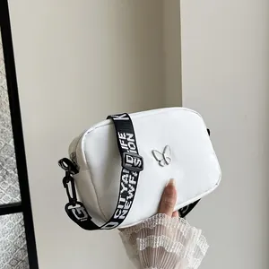 Sac bandoulière minimaliste en nylon blanc avec logo papillon et large sangle