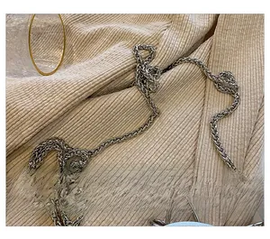Close-up of a silver woven metal chain strap with a D-ring for a luxury evening clutch