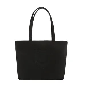 Minimalist black nylon mini tote bag with heart smile patch and dual handles