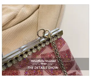Detail of pink sequin clutch featuring rhinestone frame and detachable silver metal strap