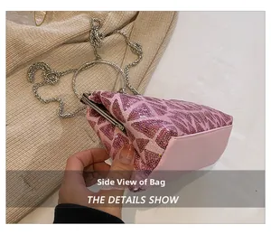Side view detail of pink sequin clutch with silver metal ring handle and chain strap