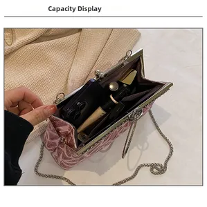 Pink embroidery clutch bag interior showing space for smartphone and lipsticks