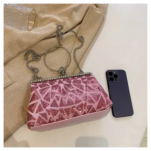 Detail of pink sequin evening bag with glitter triangle pattern and metal handle