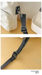 Close-up of black nylon strap with adjustable plastic hooks on a white bucket bag