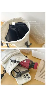 Detail of white quilted nylon bucket bag interior pocket showing large storage capacity
