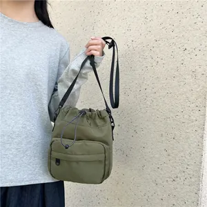 Olive green nylon drawstring bucket bag for women, lightweight casual crossbody style