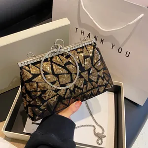 Elegant black evening clutch with gold sequins, diamond ring handle and chain strap