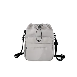 Lightweight grey nylon bucket bag with large capacity and adjustable shoulder strap