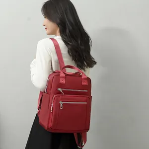 Women's red quilted backpack with large capacity and multi-zipper pockets for casual use
