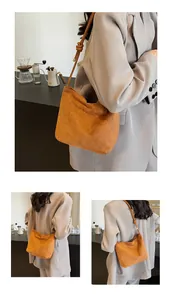 Detail of tan suede bucket bag featuring minimalist knotted shoulder strap design