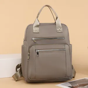 Quilted nylon backpack with dual top handles and metallic zippers in khaki brown