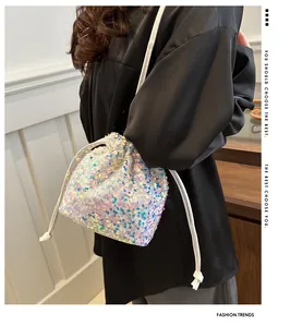 Close-up of sparkling sequin bucket bag with iridescent finish and drawstring closure