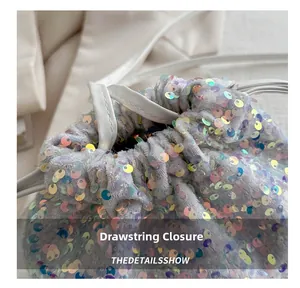 Detail of shimmering iridescent sequins and drawstring closure on a bucket bag