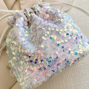 Macro shot of iridescent sequins and drawstring closure on a shimmering bucket bag