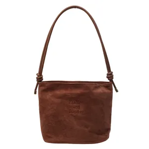 Minimalist large brown suede bucket shoulder bag with knotted straps for women