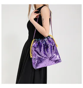 Detail of purple sequin bucket bag featuring yellow drawstring and gold chain strap