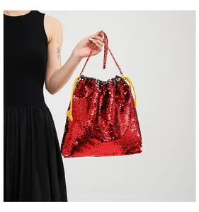 Detail of red sequin drawstring bucket bag featuring a classic metal chain strap