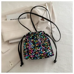Detailed view of iridescent sequins and drawstring closure on a mini bucket bag