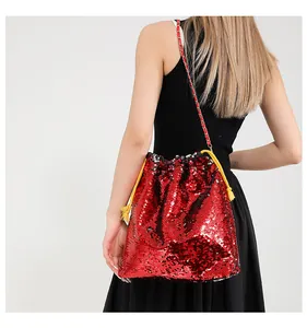 Detail of red sequin drawstring bag with gold-red metal chain and shiny reflective finish