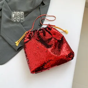 Sparkly red sequin bucket bag with gold chain strap and yellow drawstring closure