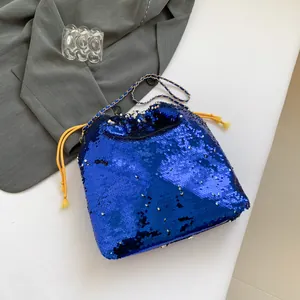 Sparkling blue sequin bucket bag with gold chain strap and drawstring closure