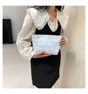 Fashionable white sequin clutch bag with pearlescent finish and smooth metal zipper