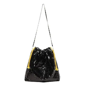 Fashionable black sequin bucket bag with bright yellow drawstrings and metal chain strap