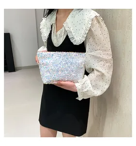 Detail of white iridescent sequin clutch bag with shimmering pearlescent finish