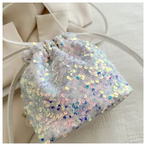 Detail of lavender sequin drawstring bucket bag with iridescent shimmer effects
