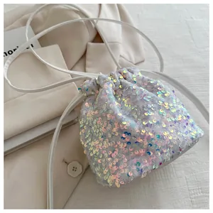 Detail of holographic sequins on drawstring bucket bag with shiny metallic finish