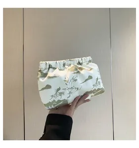 Detail of drawstring toiletry bag with Chinese landscape ink painting held by hand