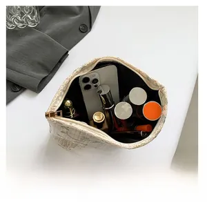 Detailed top view of embroidered lace bag showing large capacity for cosmetics and phone