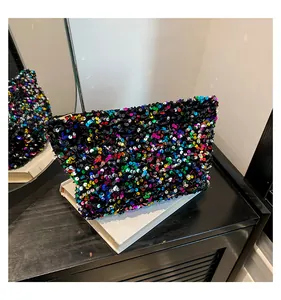 Macro shot of colorful sequins and gold zipper detail on the rectangular clutch bag