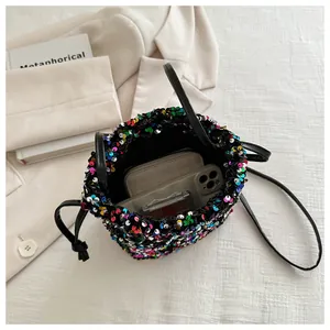 Top view of sequined drawstring bucket bag showing spacious interior with personal items