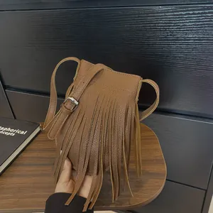 Vintage brown tassel crossbody bag in pebbled faux leather with adjustable strap