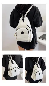 Detail of off-white casual backpack with adjustable straps and multi-pocket structure
