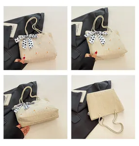 Détails du sac en paille avec broderie marguerite et ruban à pois élégant