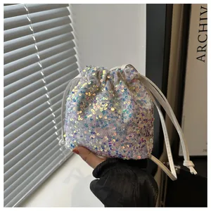 Detailed view of iridescent sequin drawstring bucket bag with shimmering light effect