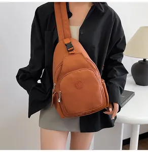 Caramel nylon chest bag featuring multiple zipper compartments and a Sport rubber logo