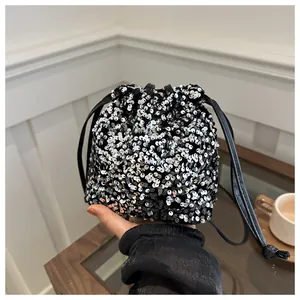 Detailed view of shimmering silver and black sequins on a mini drawstring bucket bag