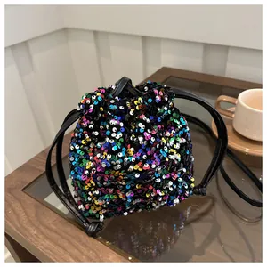 Detail of colorful sequins and drawstring closure on a stylish mini bucket bag