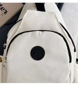 Close-up of white nylon chest bag featuring a black Sport logo and metallic zippers