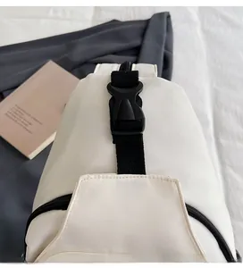 Close-up of durable buckle and nylon fabric texture on beige minimalist chest bag